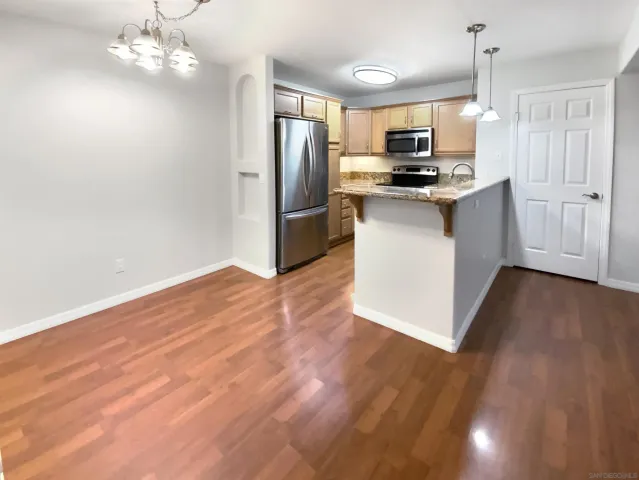 a kitchen with stainless steel appliances a refrigerator sink and microwave