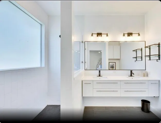 a bathroom with a sink vanity and a mirror