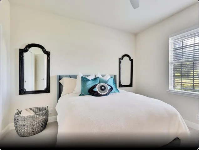 a bedroom with bed and a window