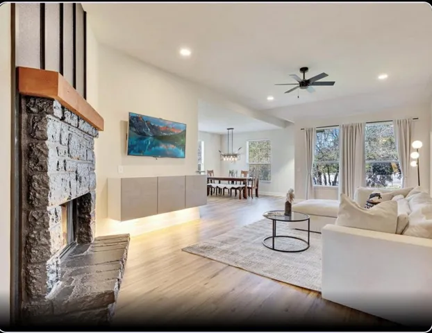 a living room with fireplace furniture and a flat screen tv