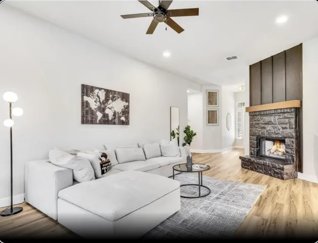 a living room with furniture and a fireplace