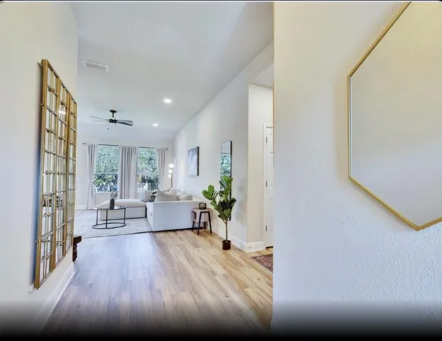 a living room with furniture and wooden floor