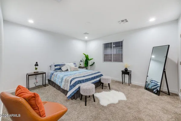 a bed room with a bed and a chair