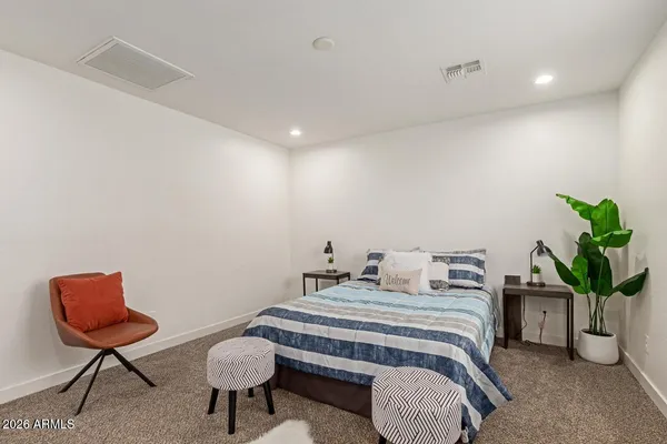 a bedroom with a bed and chair