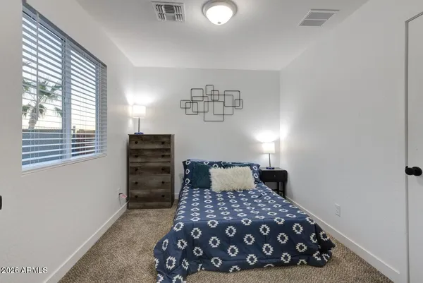 a bedroom with a bed and a window