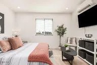 a bedroom with a bed and a flat screen tv
