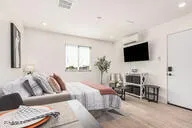 a bedroom with furniture and a flat screen tv