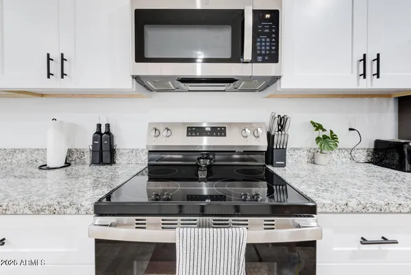 a kitchen with granite countertop a stove and a sink