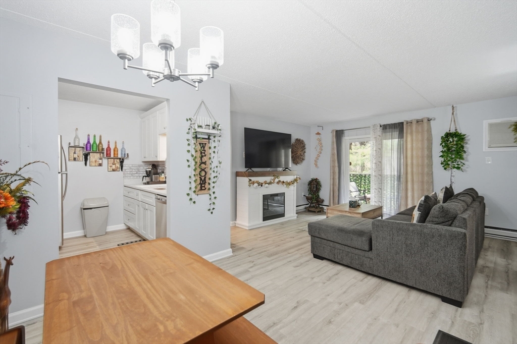 32 Maple Crest Circle, Unit G Holyoke, MA 01040 - Photo 12 of 34 a living room with furniture and a flat screen tv