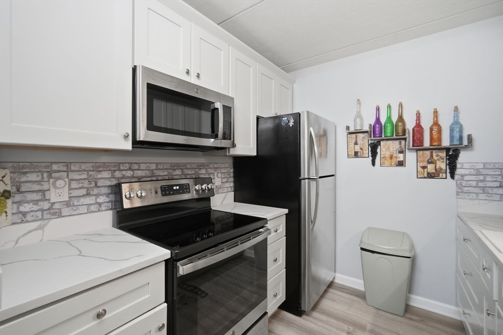 32 Maple Crest Circle, Unit G Holyoke, MA 01040 - Photo 14 of 34 a kitchen with a refrigerator stove and microwave