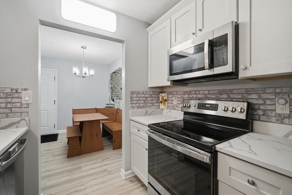 32 Maple Crest Circle, Unit G Holyoke, MA 01040 - Photo 17 of 34 a kitchen with a stove and a microwave