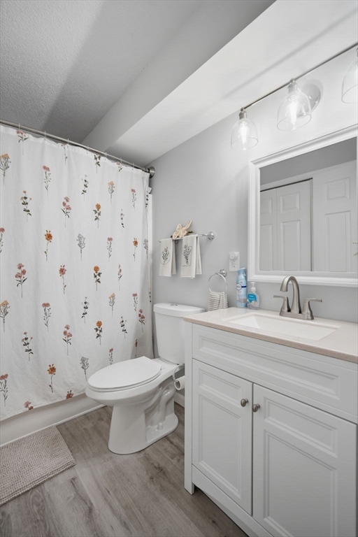 32 Maple Crest Circle, Unit G Holyoke, MA 01040 - Photo 19 of 34 a bathroom with a sink toilet a mirror and shower