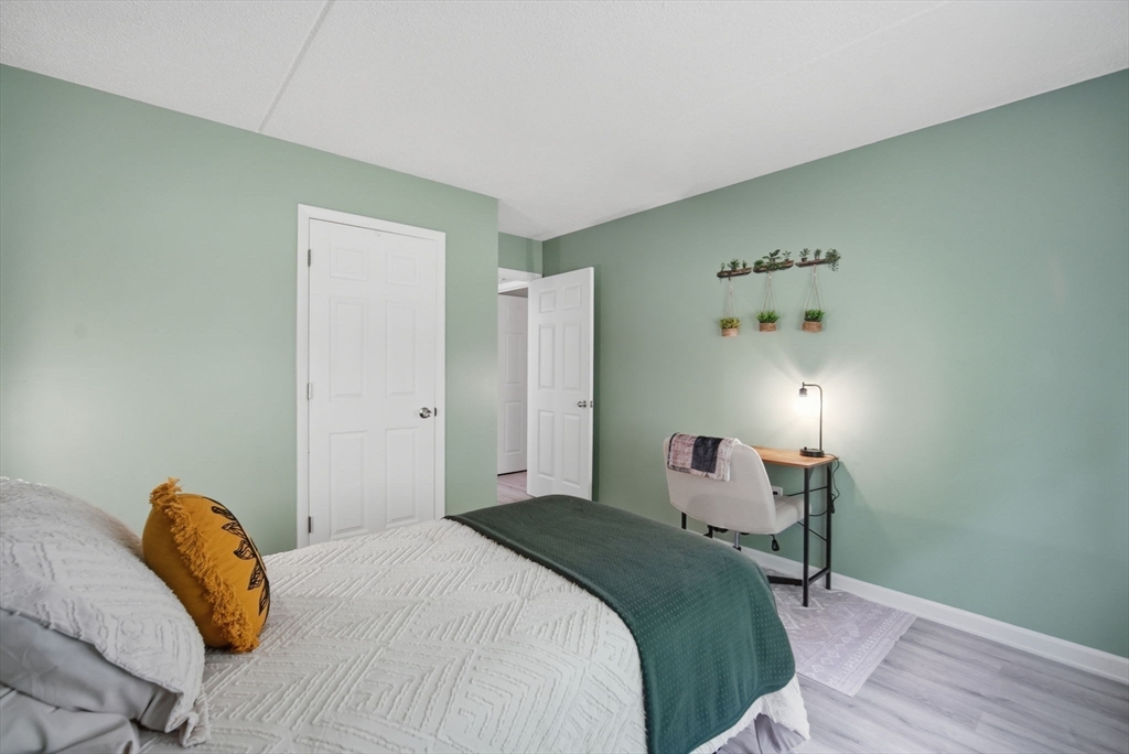 32 Maple Crest Circle, Unit G Holyoke, MA 01040 - Photo 22 of 34 a bedroom with a bed and a lamp with the table