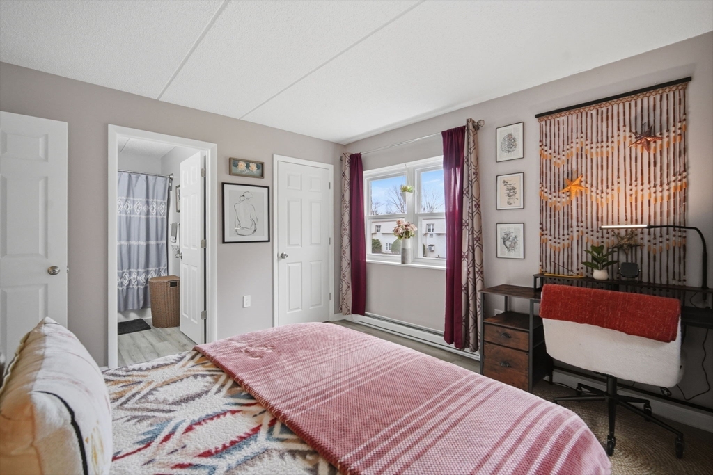 32 Maple Crest Circle, Unit G Holyoke, MA 01040 - Photo 26 of 34 a bedroom with a bed chair and a window