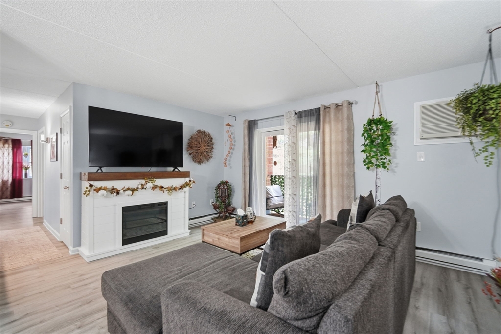 32 Maple Crest Circle, Unit G Holyoke, MA 01040 - Photo 3 of 34 a living room with furniture and a flat screen tv