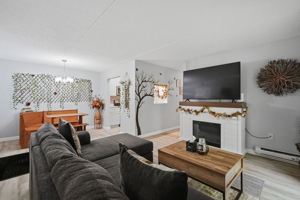 32 Maple Crest Circle, Unit G Holyoke, MA 01040 - Photo 5 of 34 a living room with furniture and a flat screen tv