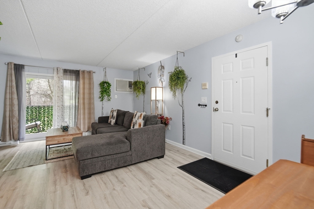 32 Maple Crest Circle, Unit G Holyoke, MA 01040 - Photo 8 of 34 a living room with furniture and a large window