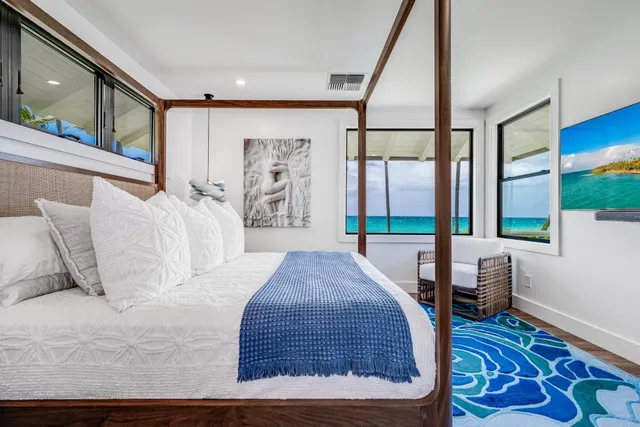 a bed sitting in a bedroom next to a window