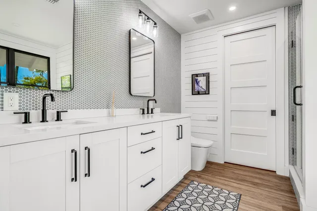 a bathroom with a double vanity sink a mirror and a