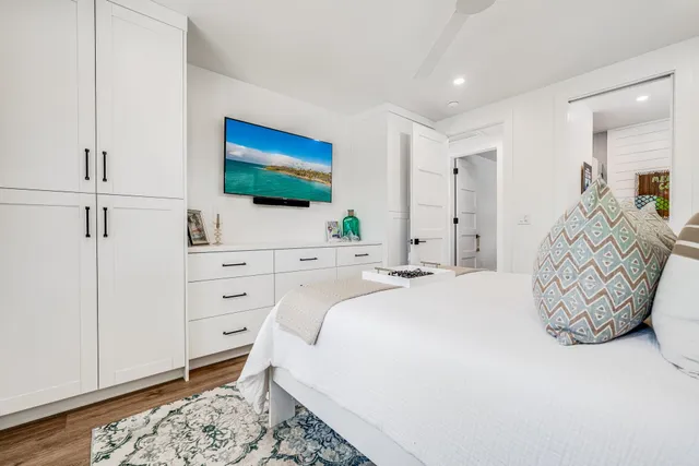 a bedroom with a bed and a flat screen tv