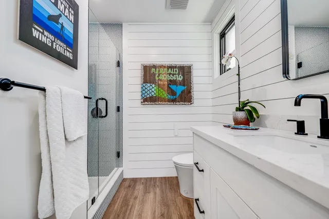 a bathroom with a sink a mirror and shower
