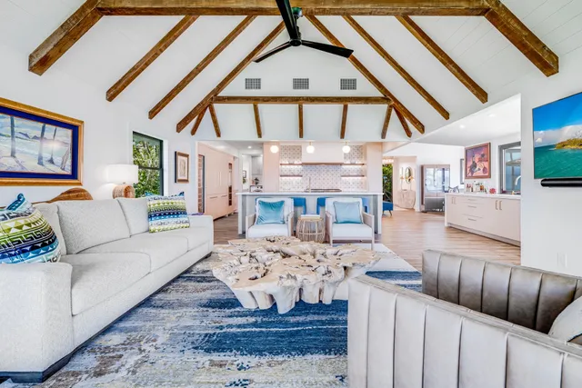 a living room with furniture a fireplace and a large window