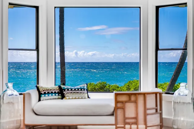 a view of a balcony with chair and a floor to ceiling window