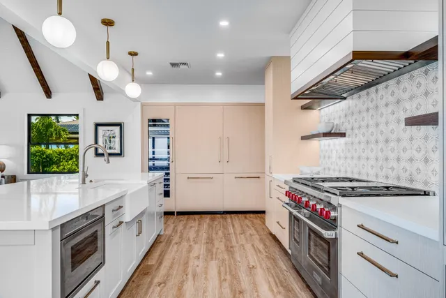 a kitchen with granite countertop a stove and a sink