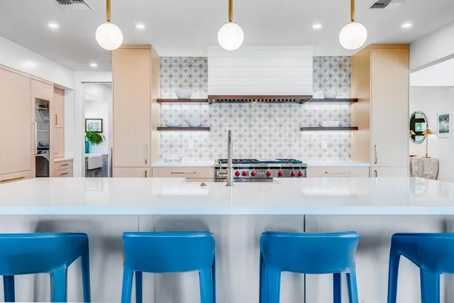 a kitchen with stainless steel appliances a sink stove and cabinets