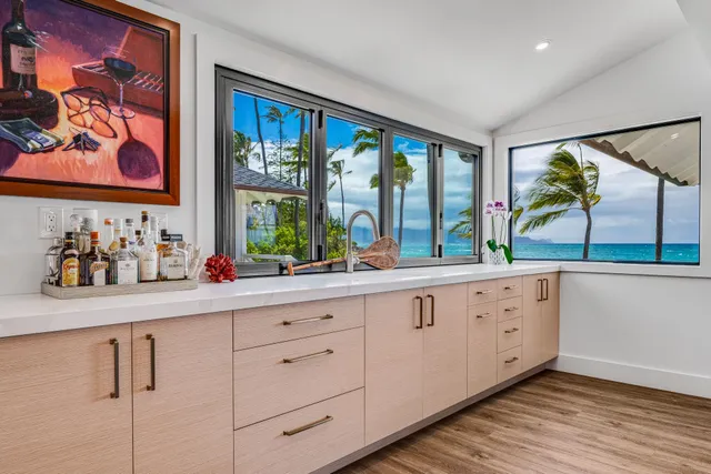 a kitchen with sink and large window