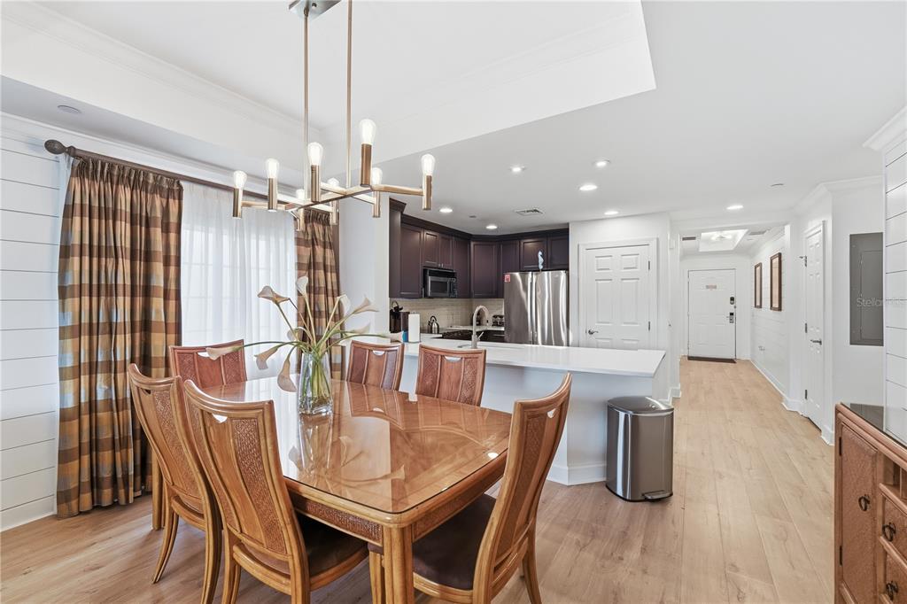 1354 Centre Ct Ridge Drive, Unit 204 Reunion, FL 34747 - Photo 11 of 46 a dining room with furniture a chandelier and wooden floor