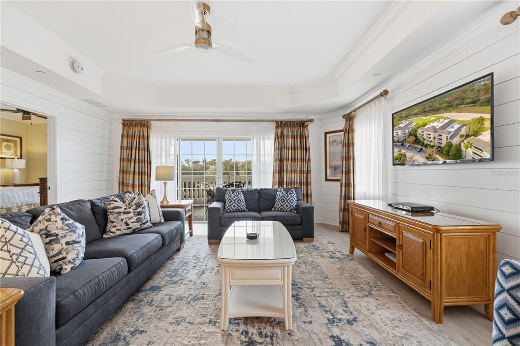 1354 Centre Ct Ridge Drive, Unit 204 Reunion, FL 34747 - Photo 16 of 46 a living room with furniture and a flat screen tv