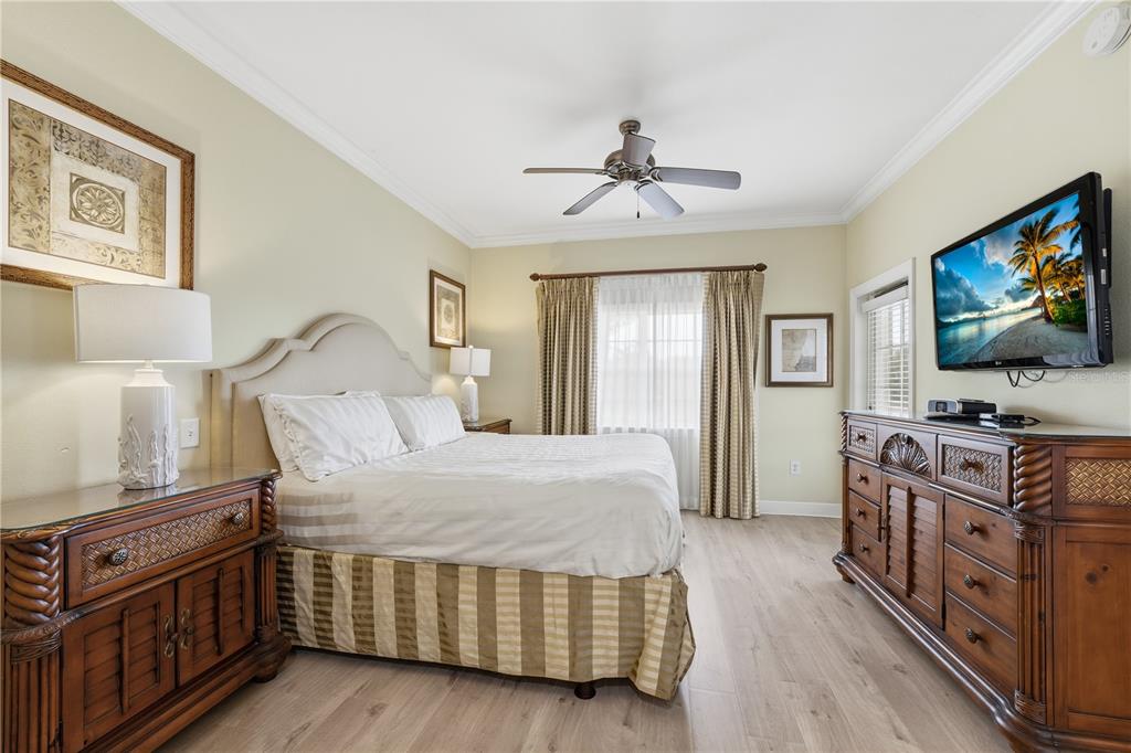 1354 Centre Ct Ridge Drive, Unit 204 Reunion, FL 34747 - Photo 20 of 46 a bedroom with furniture and flat screen tv