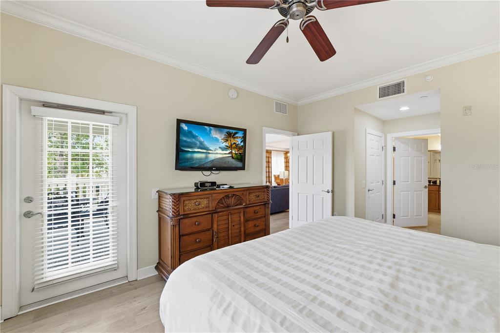 1354 Centre Ct Ridge Drive, Unit 204 Reunion, FL 34747 - Photo 21 of 46 a bedroom with a bed and a flat screen tv