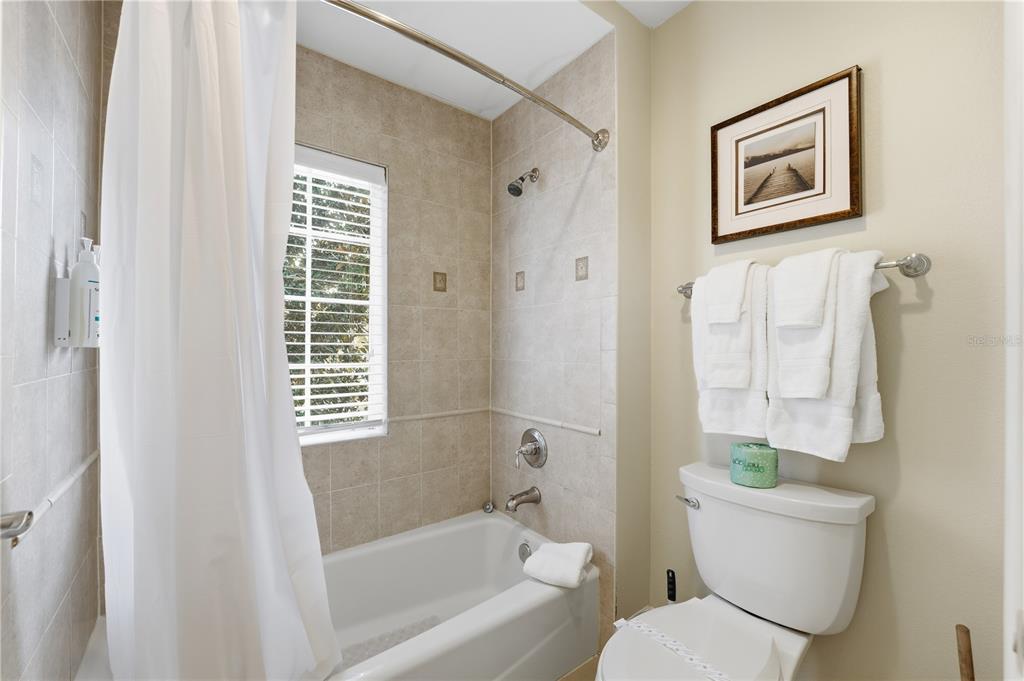 1354 Centre Ct Ridge Drive, Unit 204 Reunion, FL 34747 - Photo 28 of 46 a bathroom with a toilet and a bathtub