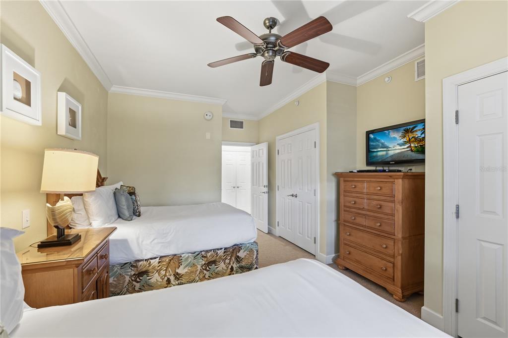 1354 Centre Ct Ridge Drive, Unit 204 Reunion, FL 34747 - Photo 30 of 46 a bedroom with a bed and a flat tv screen
