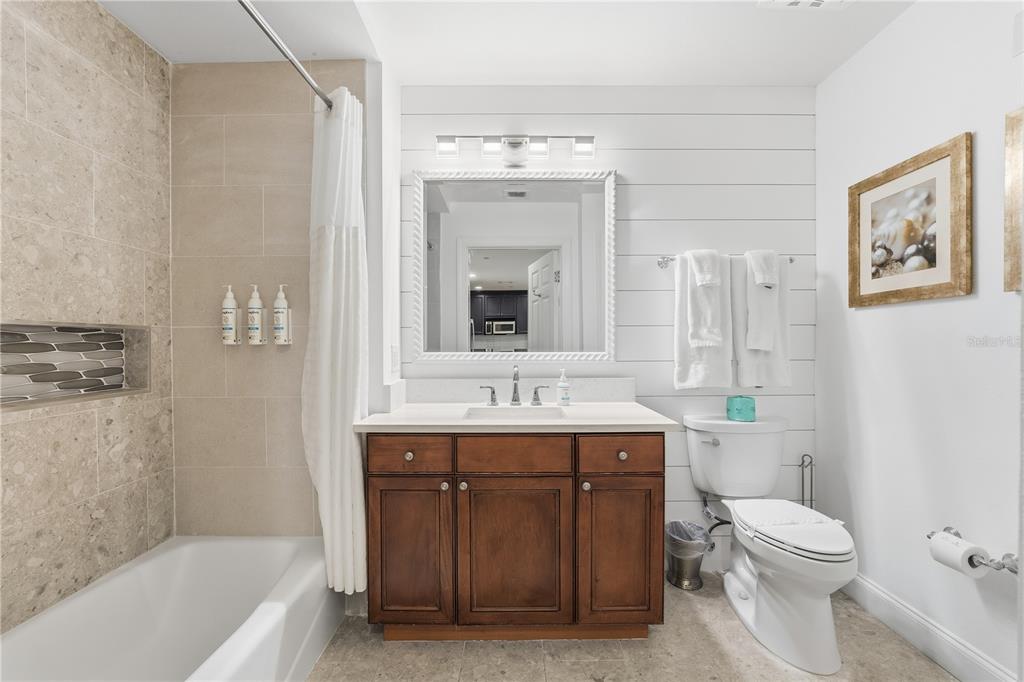 1354 Centre Ct Ridge Drive, Unit 204 Reunion, FL 34747 - Photo 31 of 46 a bathroom with a toilet a sink a mirror a bathtub and vanity