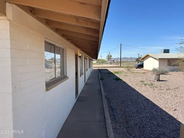 a bathroom with a granite countertop sink and washing machine