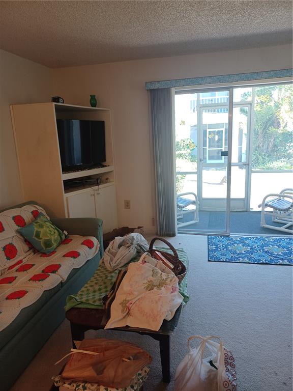 215 South McMullen Booth Road, Unit 183 Clearwater, FL 33759 - Photo 11 of 12 a bedroom with a bed and flat screen tv