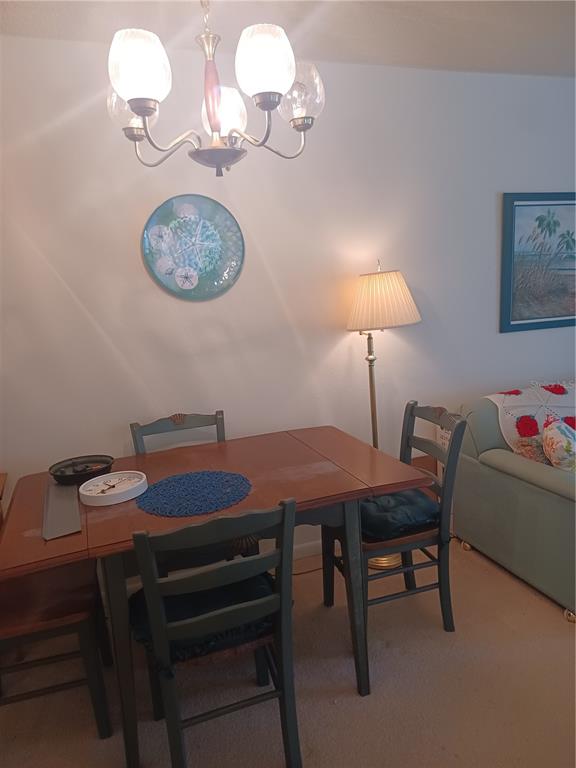 215 South McMullen Booth Road, Unit 183 Clearwater, FL 33759 - Photo 9 of 12 a dining room with a table chairs and a chandelier