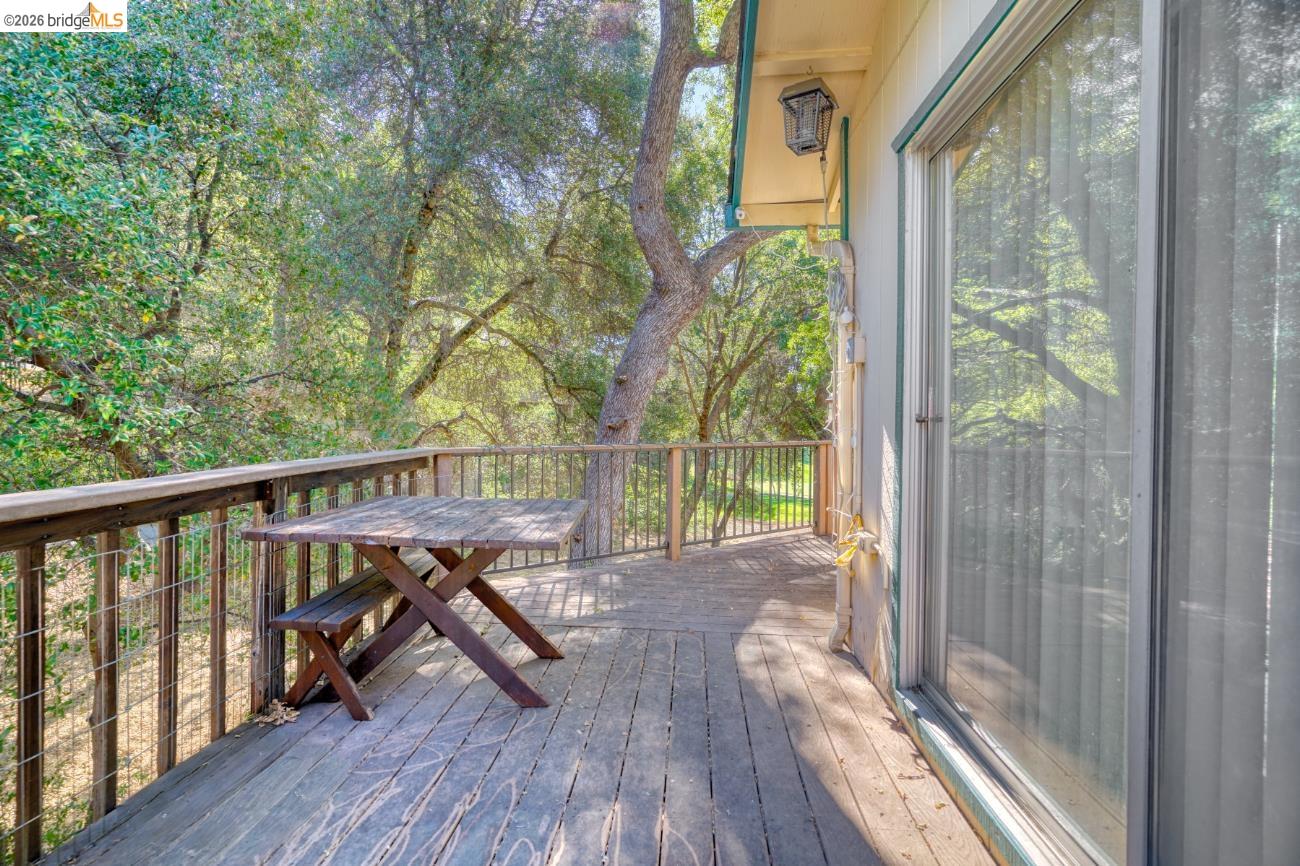 19215 Ferretti Road Groveland, CA 95321 - Photo 4 of 40 Expansive wood deck with a perimeter railing overlooking abundant natural foliage