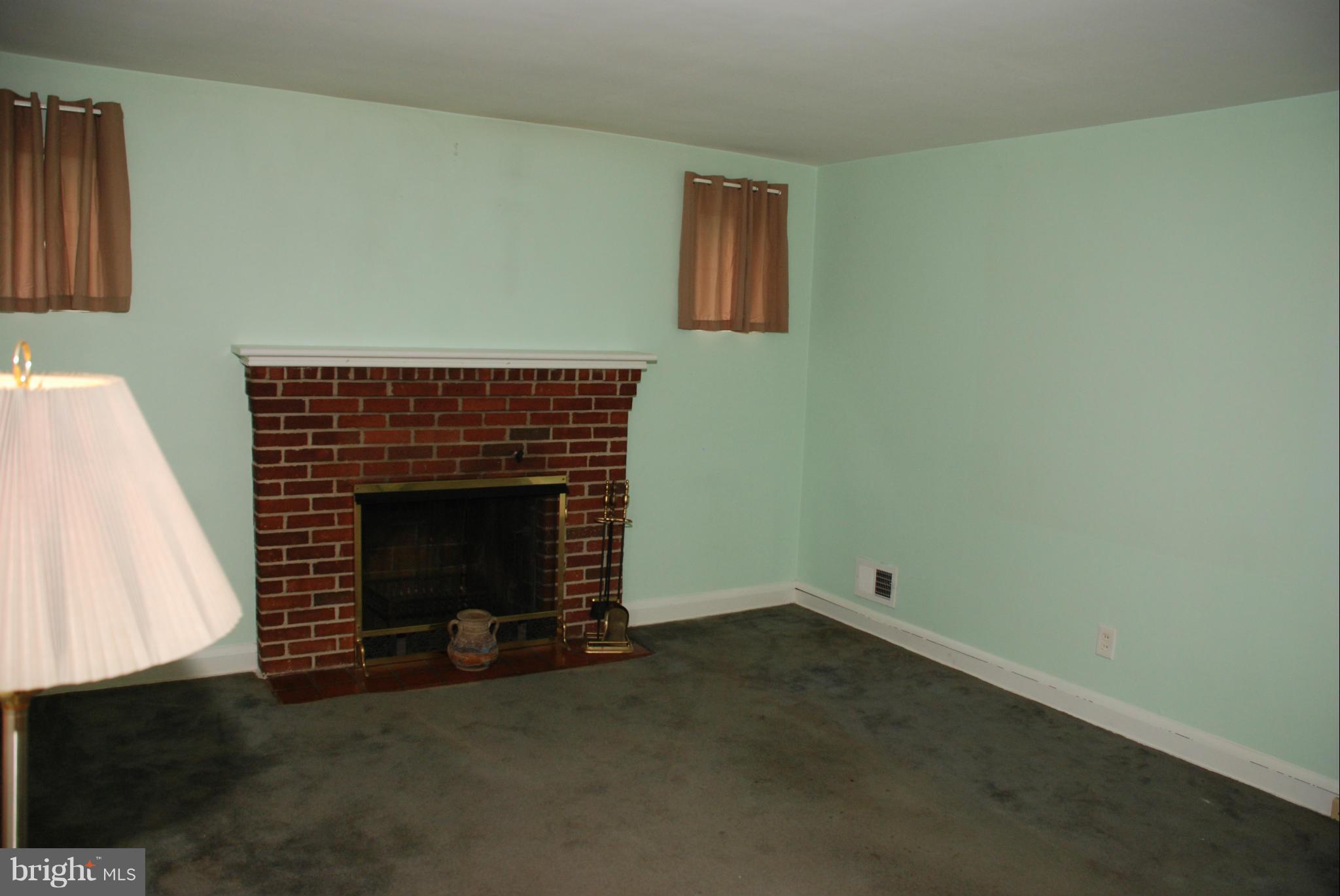 239 Gralan Road Baltimore, MD 21228 - Photo 2 of 21 a living room with a fireplace