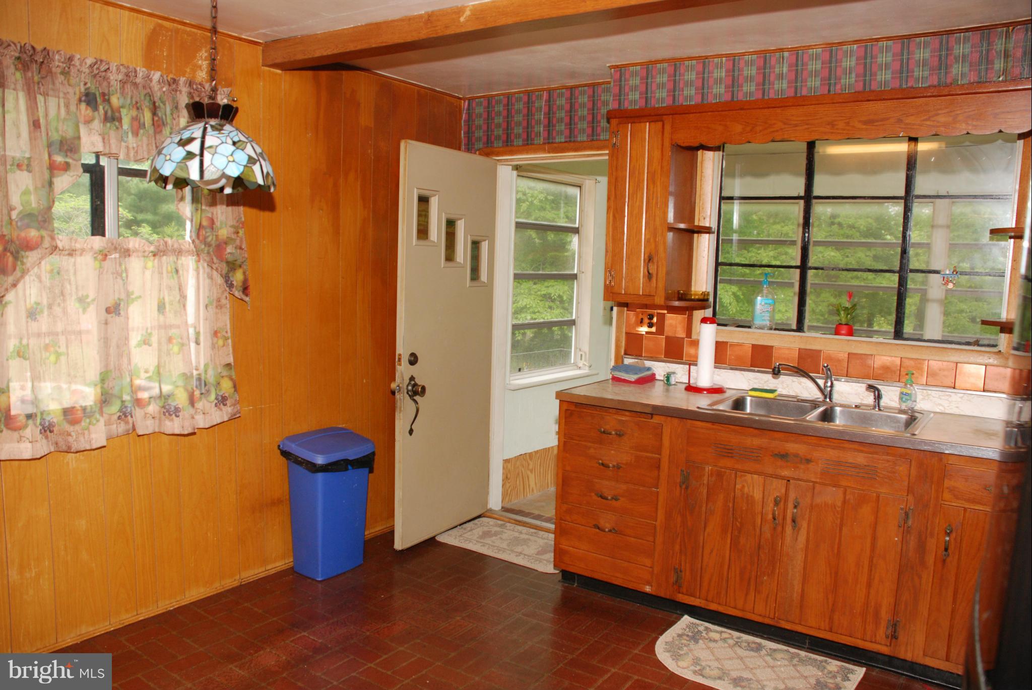 239 Gralan Road Baltimore, MD 21228 - Photo 5 of 21 a kitchen with sink a window and chairs