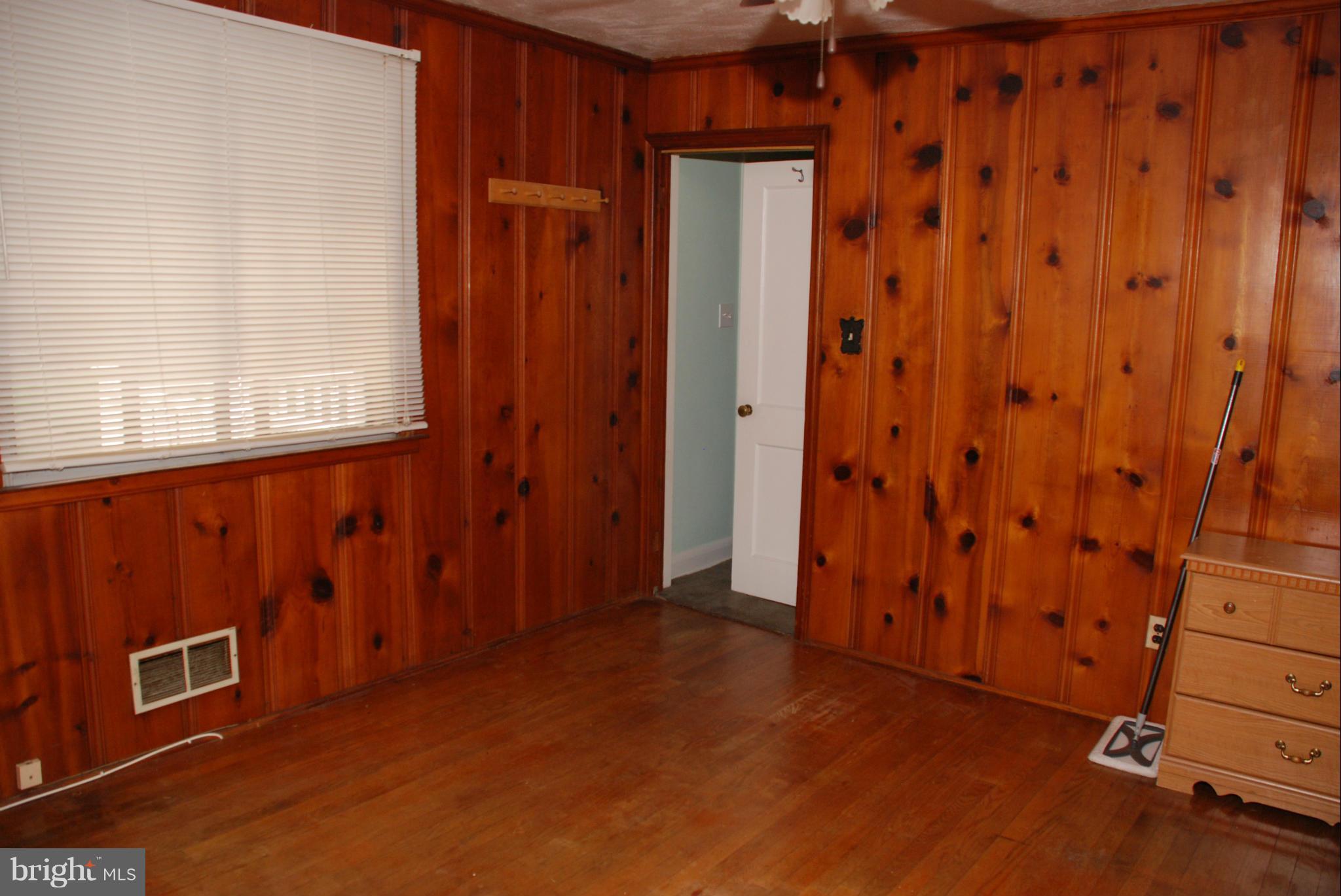 239 Gralan Road Baltimore, MD 21228 - Photo 10 of 21 a view of an empty room with wooden walls