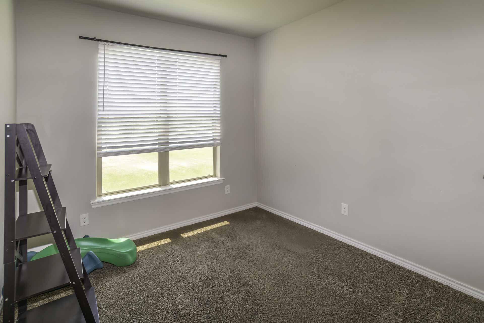 7012 12th Street Lubbock, TX 79416 - Photo 12 of 15 a view of an empty room with a window
