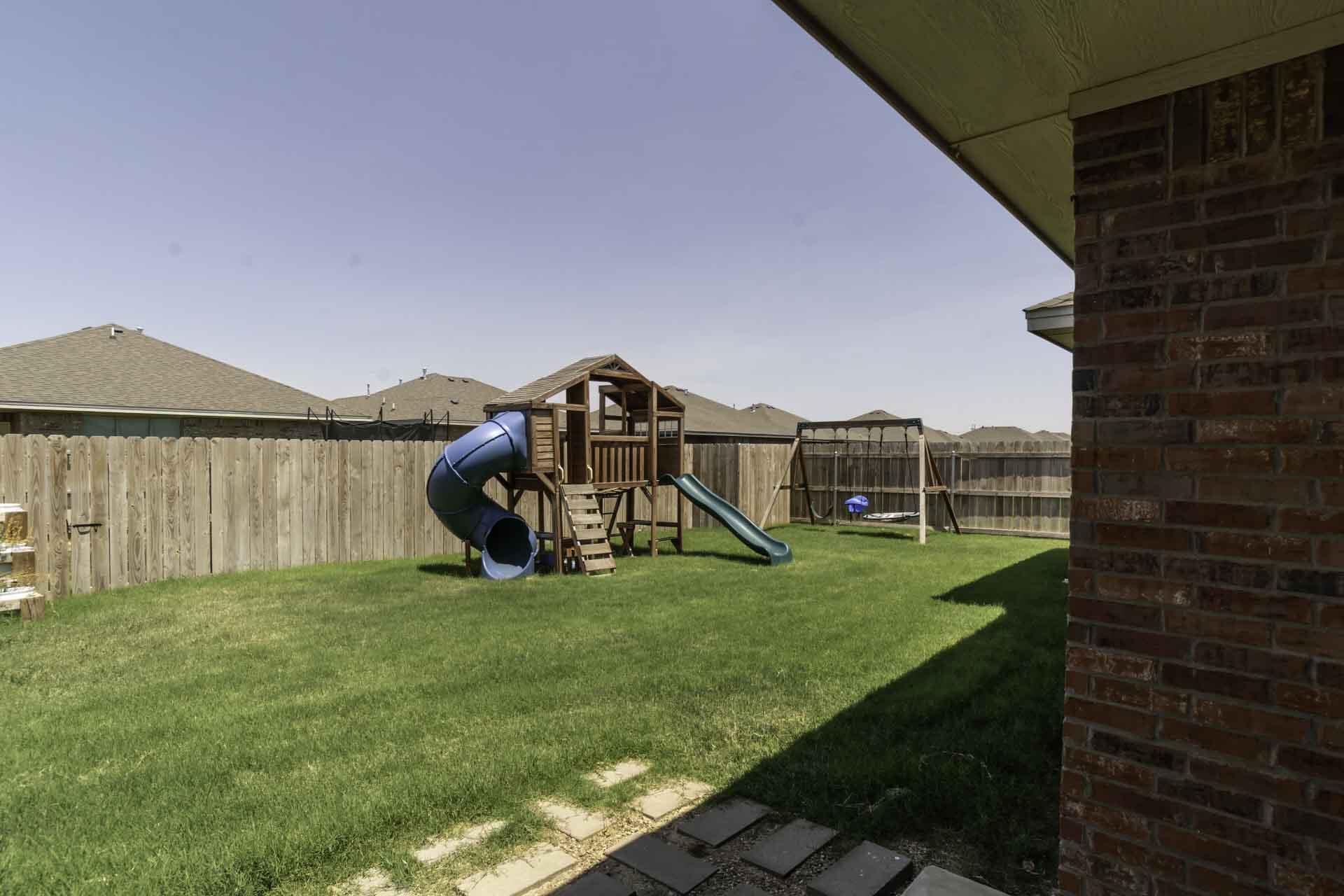7012 12th Street Lubbock, TX 79416 - Photo 2 of 15 a view of a backyard with plants and a garden