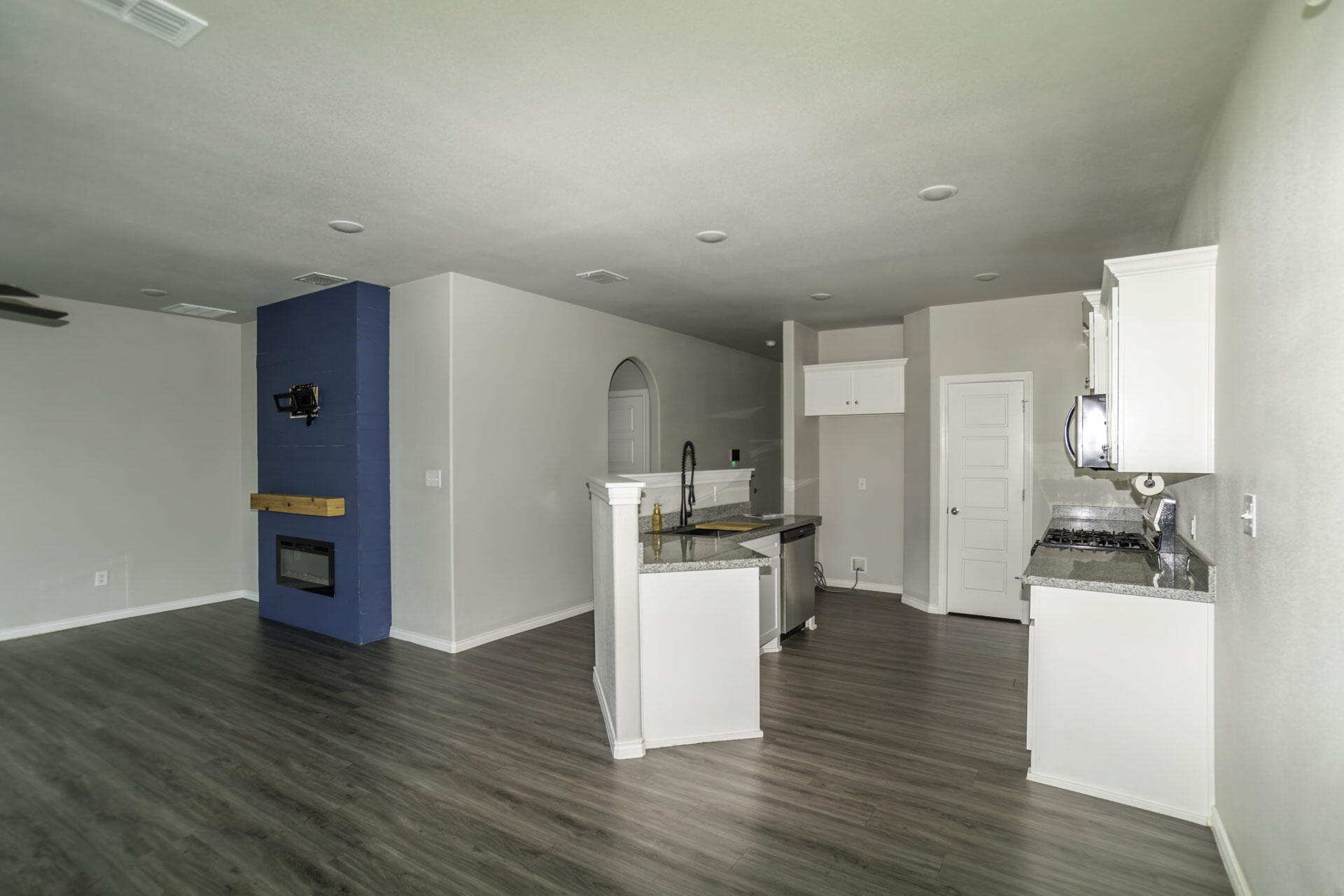 7012 12th Street Lubbock, TX 79416 - Photo 4 of 15 a kitchen with a refrigerator and a stove top oven