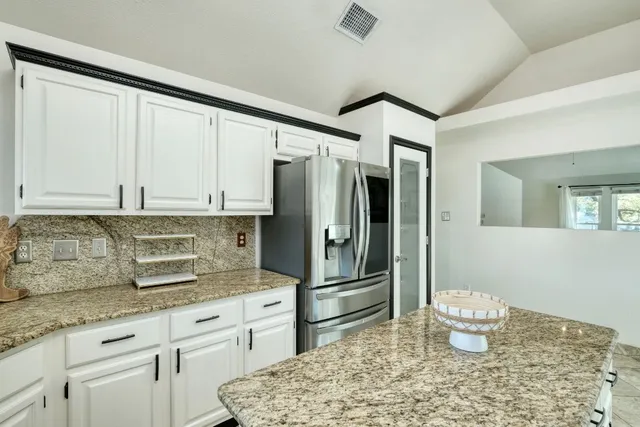 a kitchen with a refrigerator sink and stove