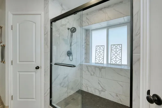 a bathroom with a shower and a sink
