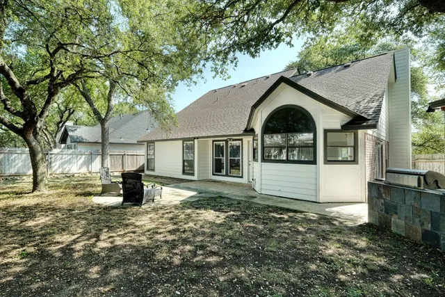 a view of a house with a tree in the yard